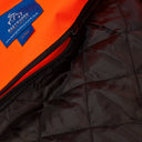 Close-up of high-visibility orange work jacket with black quilted zip-out liner