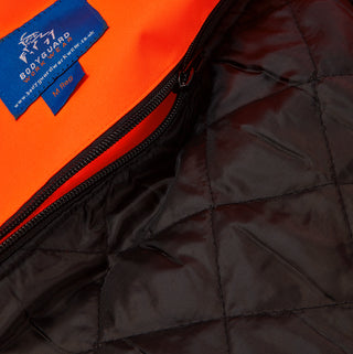Close-up of high-visibility orange work jacket with black quilted zip-out liner