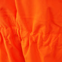 Close-up of orange hi-vis workwear fabric with stitched seams, weather-resistant material