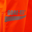 Hi-vis orange GORE-TEX workwear leg with reflective branding and zip pocket detail